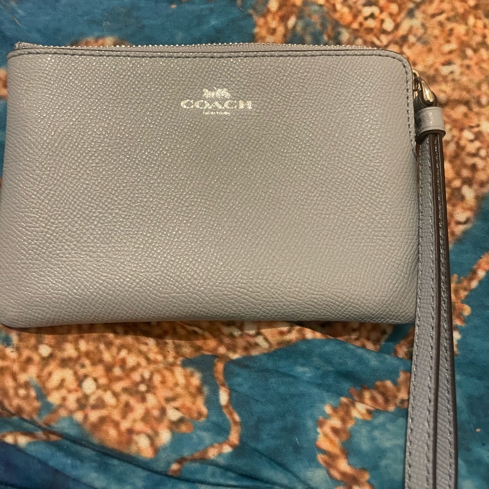 Pastel baby blue coach wristlet.